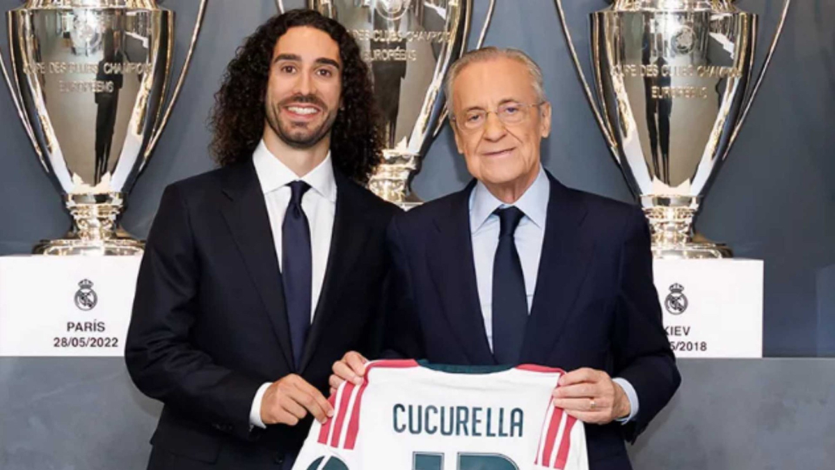 Marc Cucurella holds up a Real Madrid shirt next to Florentino Perez at his official presentation