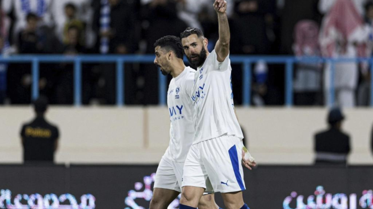 Karim Benzema stands on the pitch at Kingdom Arena during an Al Hilal match in the Saudi Pro League.