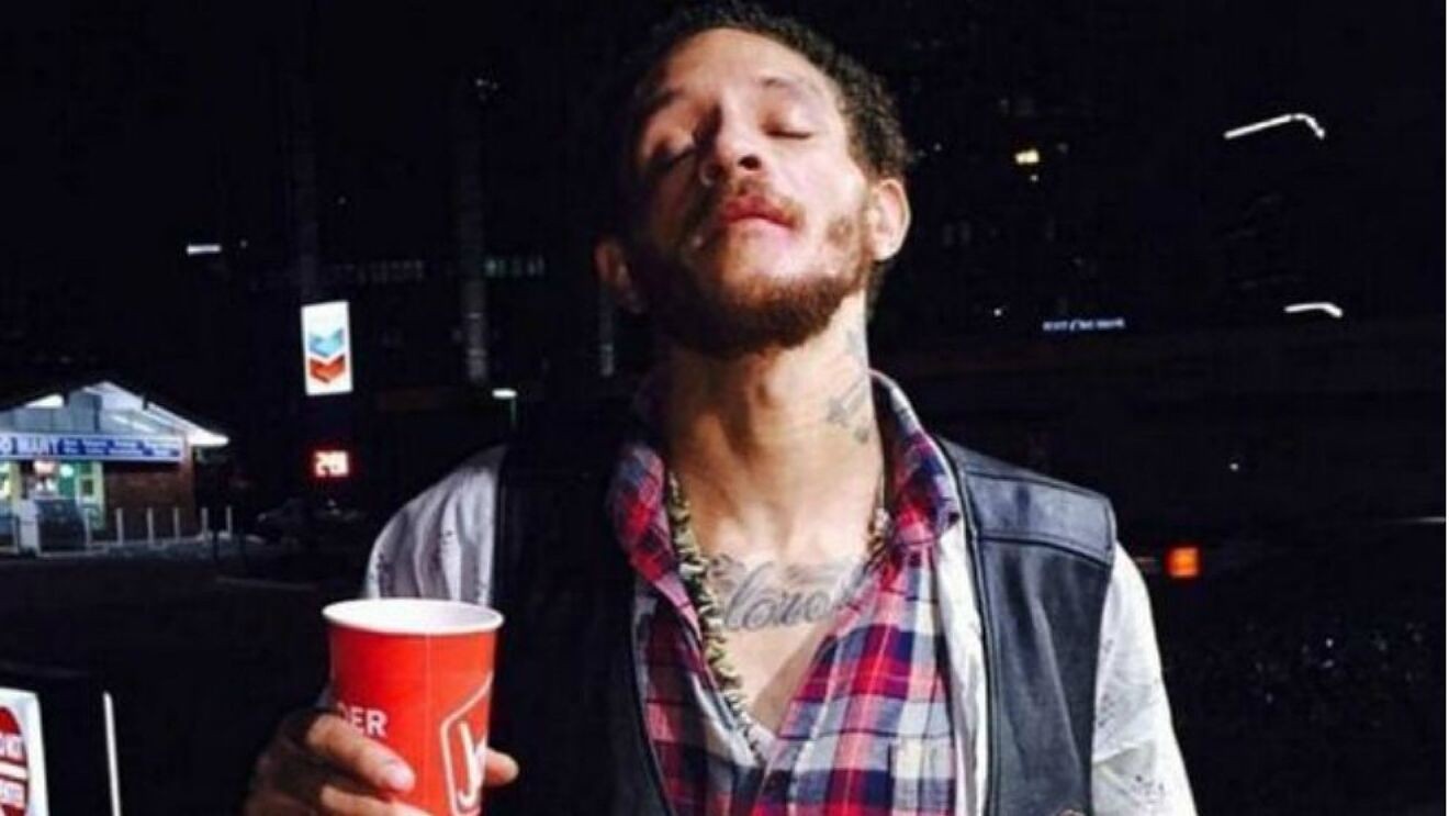 Delonte West, walks down the street with a glass.