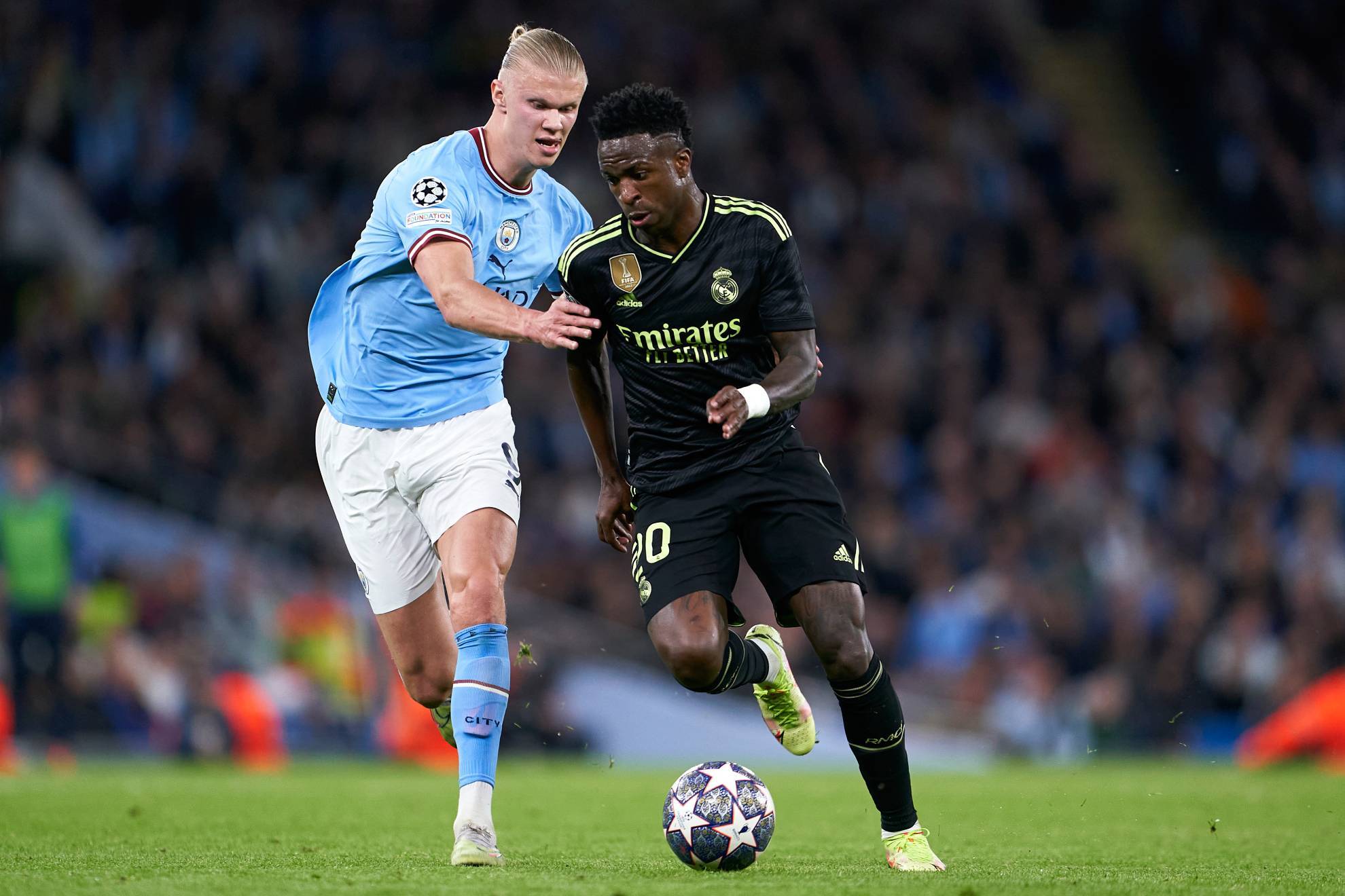 Haaland y Vinicius disputan un balón en un partido de Champions League.