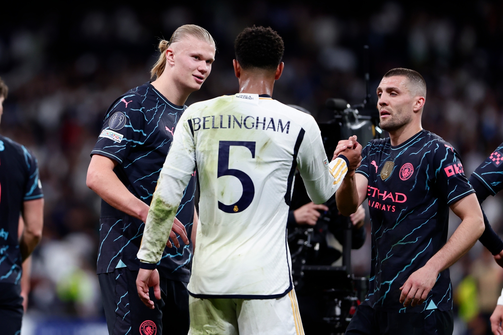 Bellingham saluda a Kovacic mientras charla con Haaland durante el último Madrid-City.