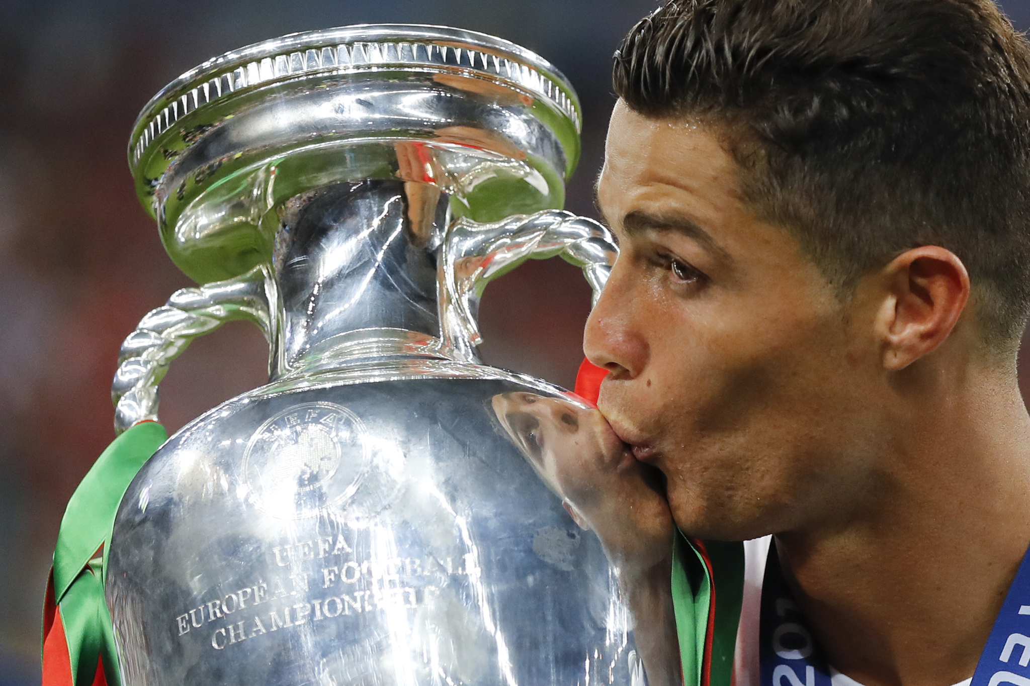 FILE - In this Sunday, July 10, lt;HIT gt;2016 lt;/HIT gt; file photo, lt;HIT gt;Portugal lt;/HIT gt;'s Cristiano Ronaldo kisses the trophy at the end of the Euro lt;HIT gt;2016 lt;/HIT gt; final soccer match between lt;HIT gt;Portugal lt;/HIT gt; and France at the Stade de France in Saint-Denis, north of Paris. The Euros kick off in Munich, Friday June 14, when host country Germany plays Scotland at Bayern Munich's Allianz Arena. The tournament begins with six groups of four teams. (AP Photo/Frank Augstein, File)