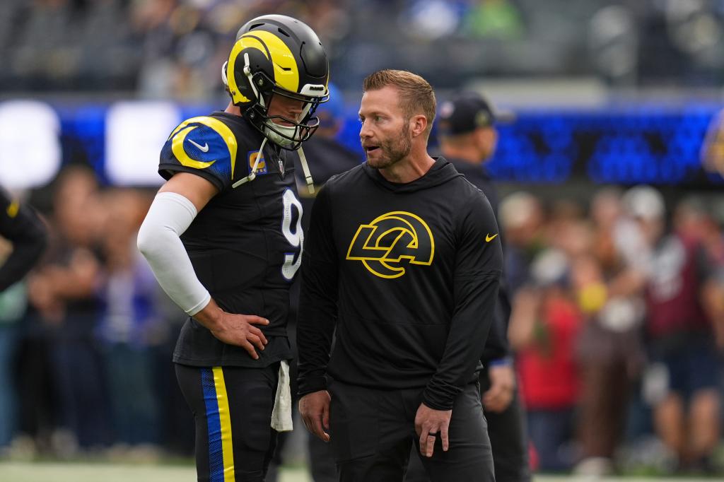 Stafford chats with his coach.