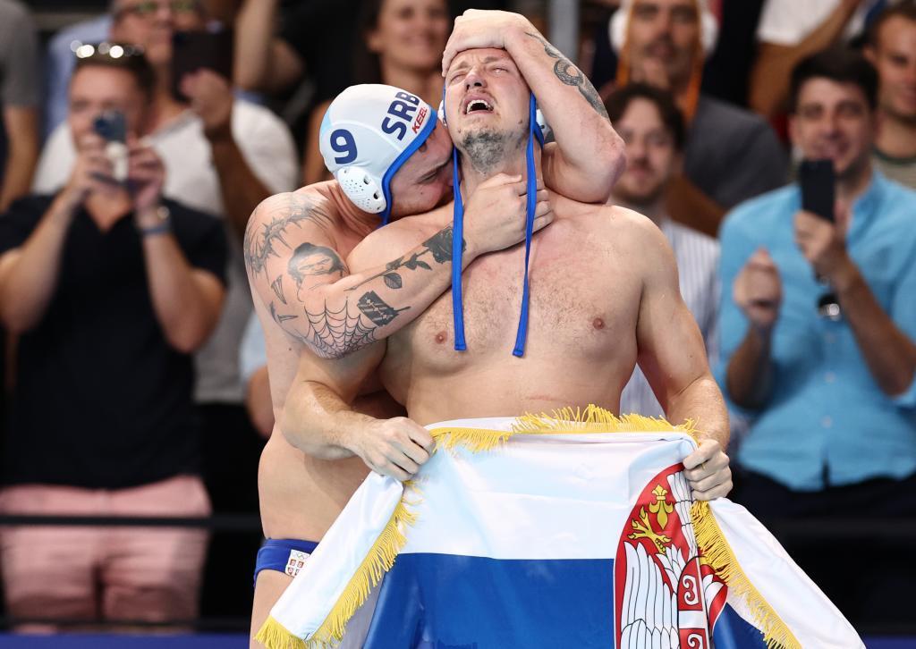 Nemanja Vico (I) y Sava Randjelovic se felicitan tras el triunfo de Serbia ante Croacia en la final masculina de waterpolo.