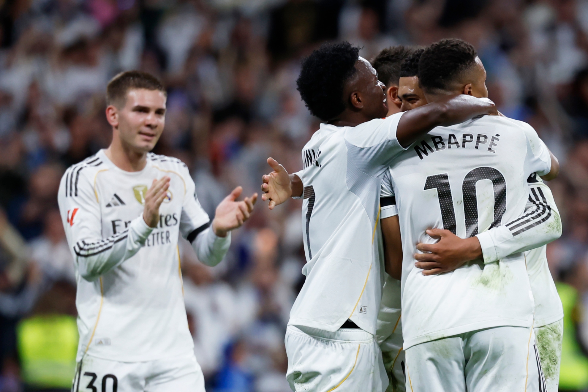 Mastantuono aplaude con Vinicius y Mbappé abrazados celebrando un gol.