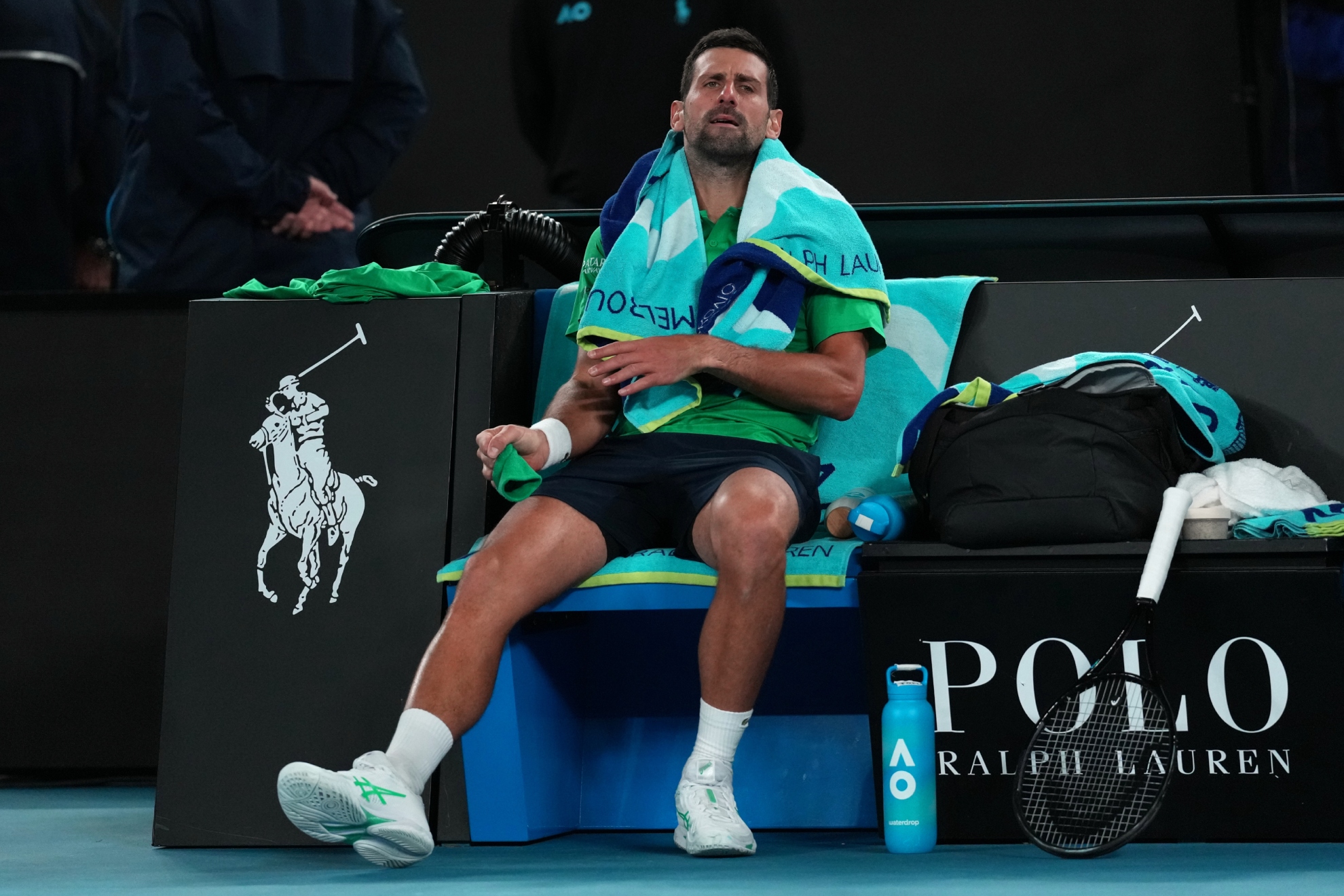 Djokovic, roto, en la silla de cambios.