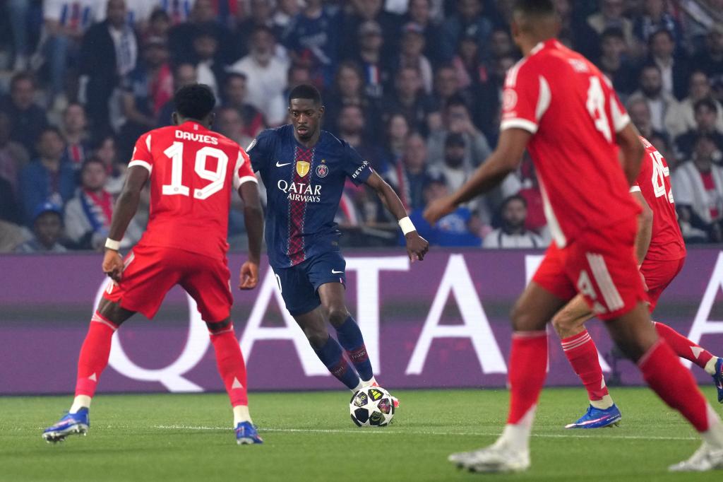 PSG's Ousmane Dembele runs with the ball at Bayern's Alphonso Davies during a Champions League semifinal, first leg, soccer match between Paris Saint-Germain and Bayern Munich in Paris, Tuesday, April 28, 2026. (AP Photo/Aurelien Morissard)