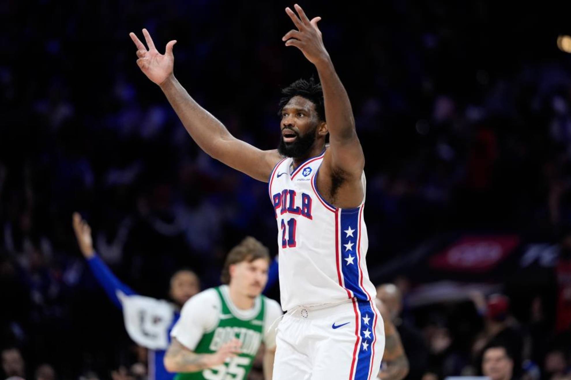 Joel Embiid celebrates a three-pointer during the game.