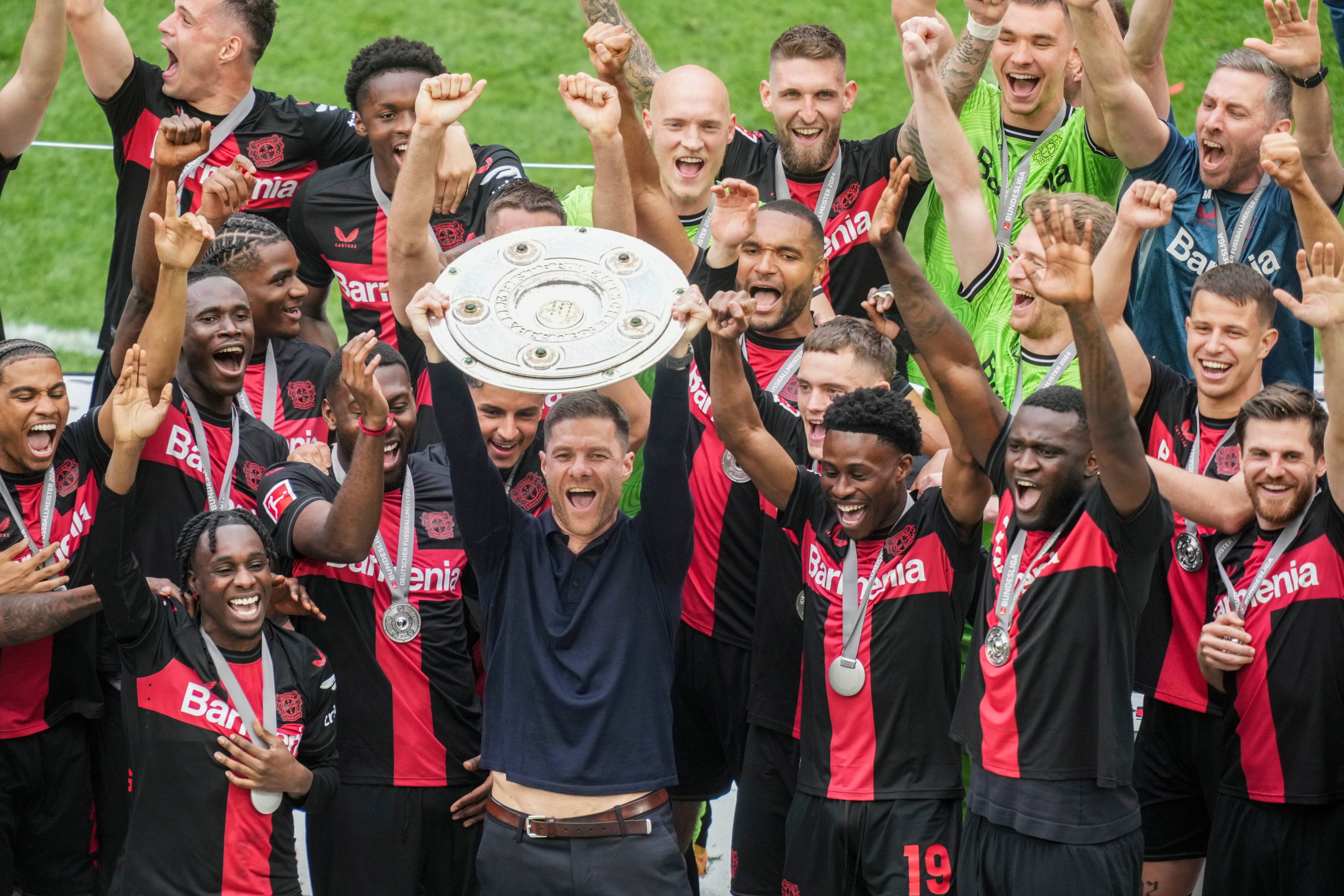 Xabi Alonso lifting the Bundesliga trophy