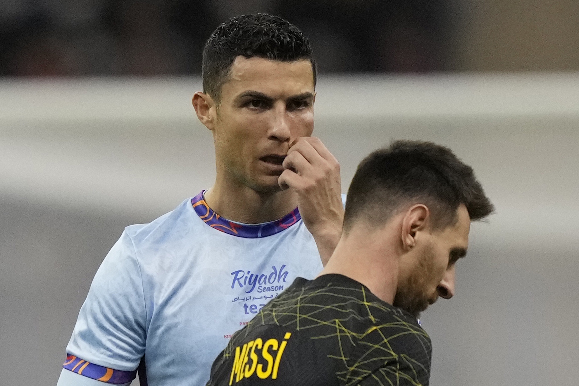 Cristiano Ronaldo gestures playing for a combined XI of Saudi Arabian teams Al Nassr and Al Hilal is flanked by PSG's Lionel Messi during a friendly soccer match, at the King Saud University Stadium, in Riyadh, Saudi Arabia, Thursday, Jan. 19, 2023. (AP Photo/Hussein Malla)