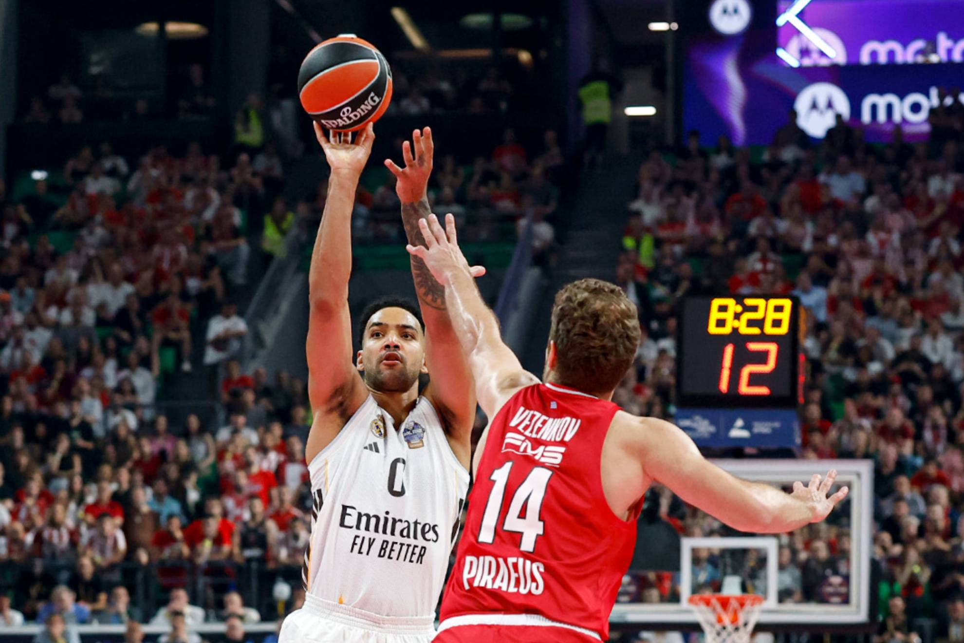 Trey Lyles launches a three-pointer over Sasha Vezenkov's defense.