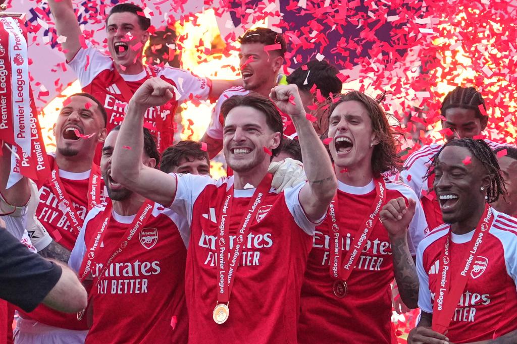 Arsenal players celebrate the league title