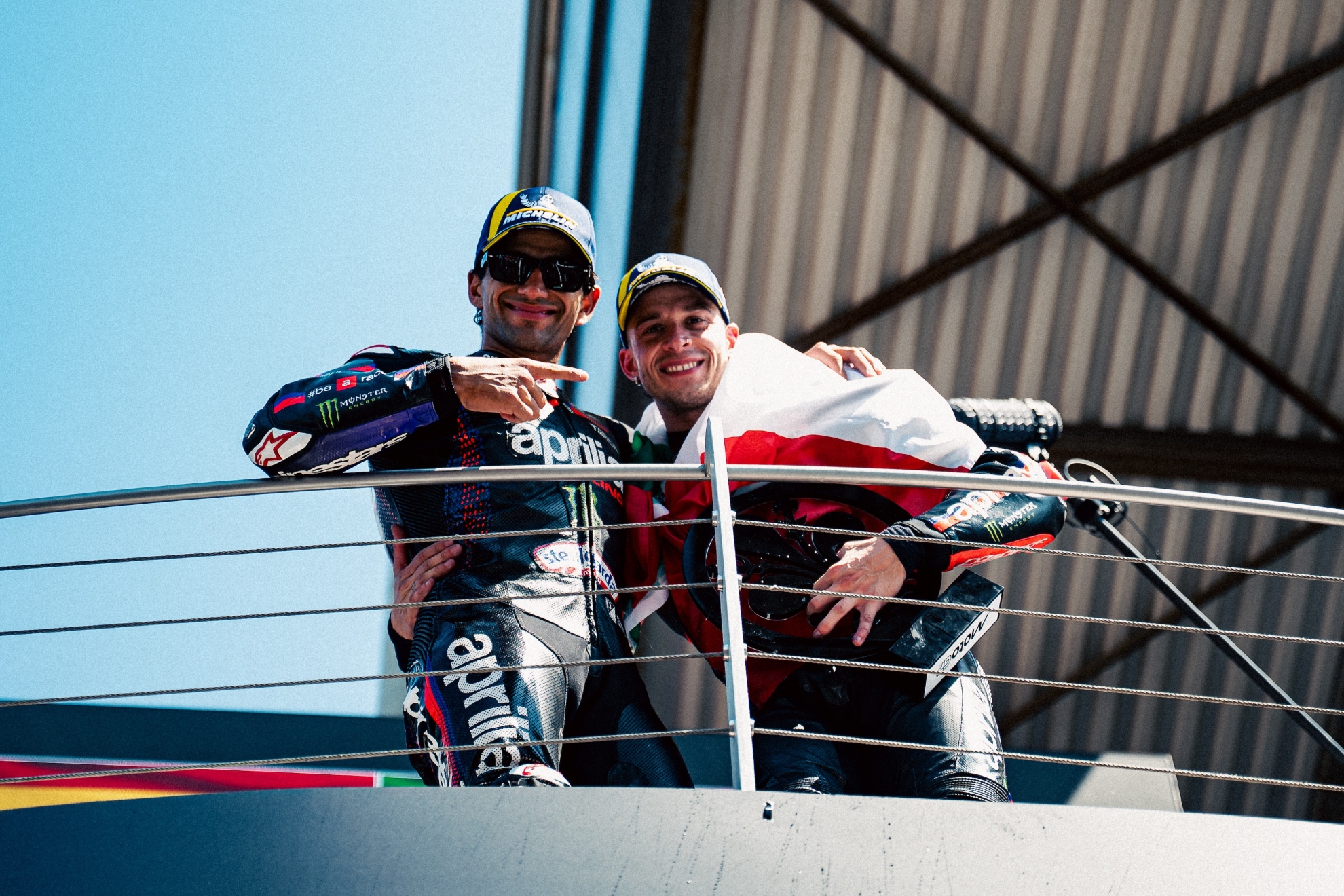 Jorge Martín points to Bezzecchi, on the podium.