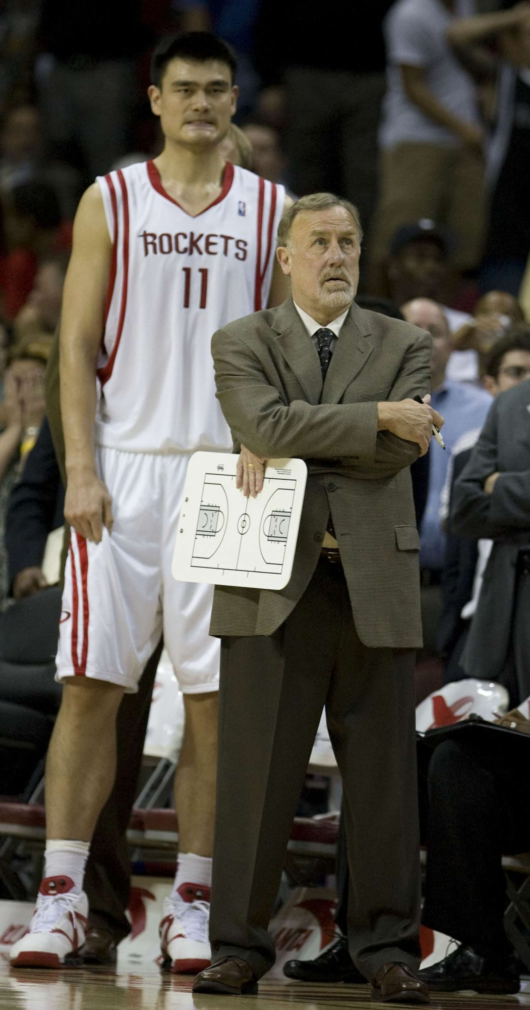 Rick Adelman, in front of Yao Ming.