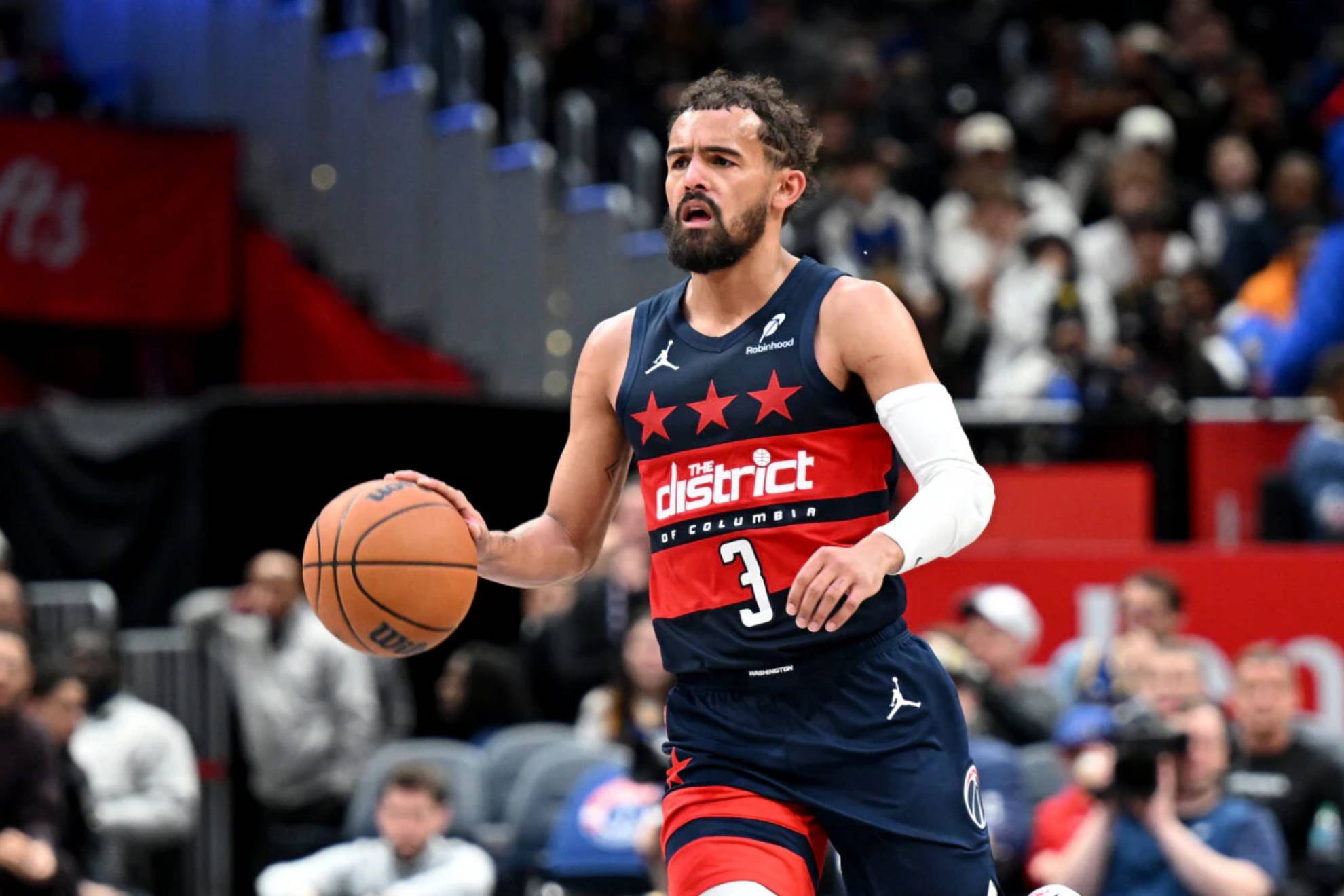 Trae Young brings the ball up on a Wizards attack.