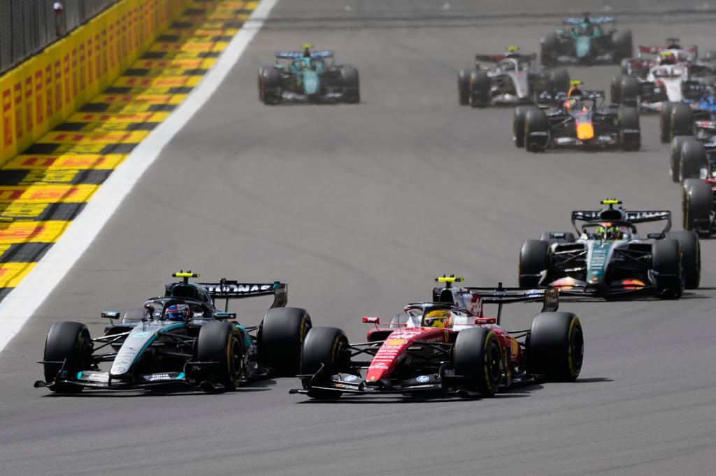 Ferrari driver Lewis Hamilton of Britain steers his car followed by Mercedes driver Andrea Kimi Antonelli of Italy and McLaren driver Lando Norris of Britain during the sprint race at the British F1 Grand Prix, in Silverstone, England, Saturday, July 4, 2026. (AP Photo/Darko Bandic)