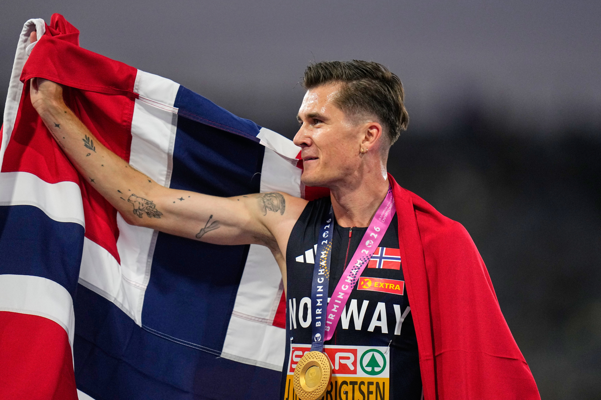 Jakob Ingebrigtsen con la bandera noruega tras su triunfo en los 5.000 metros. LAPRESSE