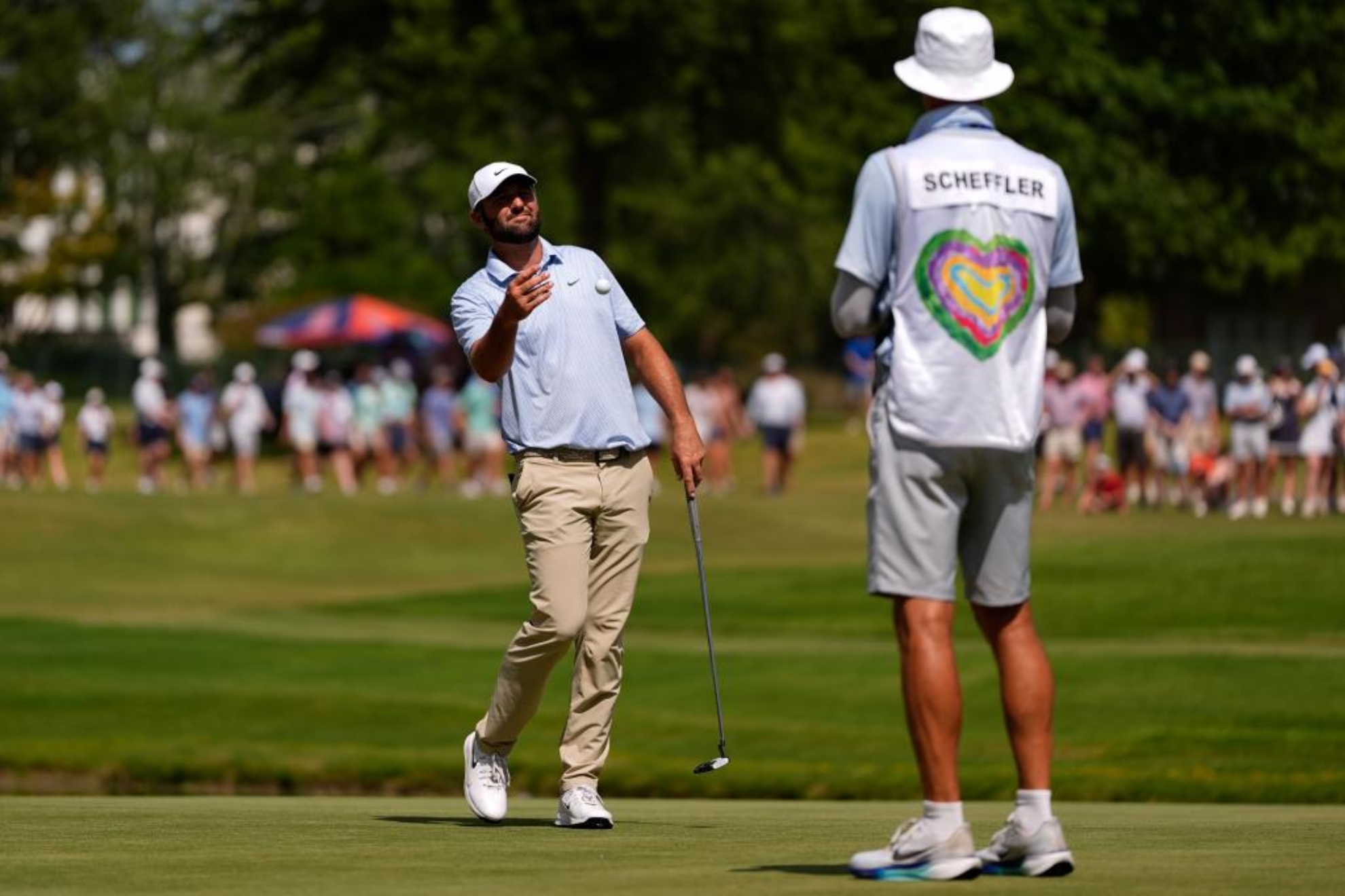 Scottie Scheffler (30) lanza la bola a su caddie LAPRESSE