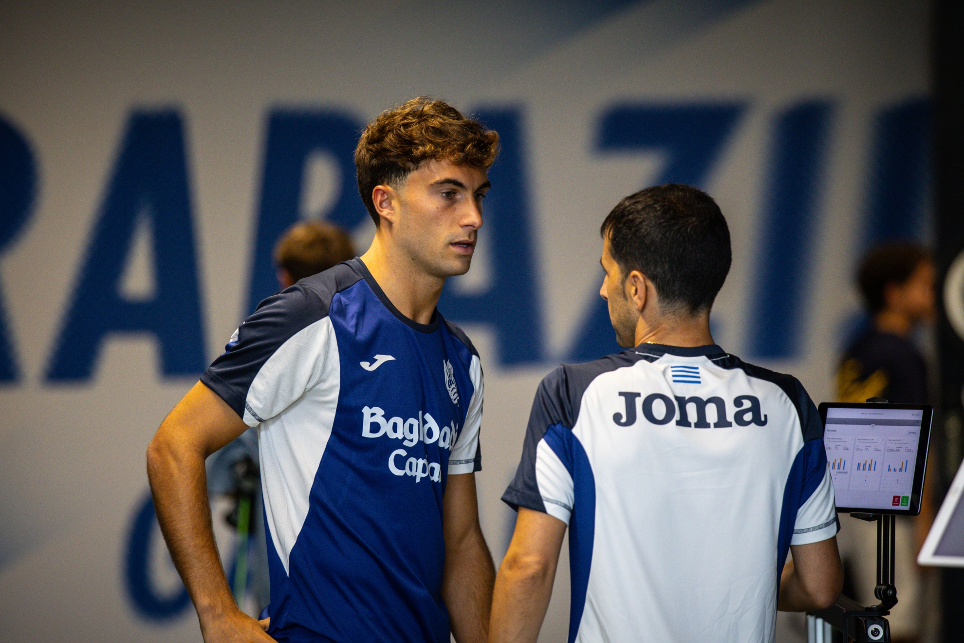 Mikel Goti charla en Zubieta con uno de los técnicos de la Real. REAL SOCIEDAD