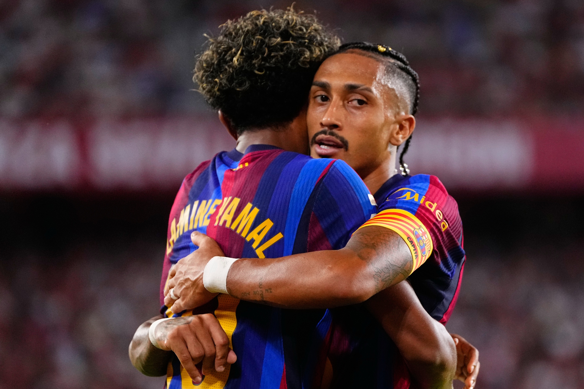 Barcelona's Raphinha, right, celebrates with Lamine Yamal after scoring his side's second goal the Spanish La Liga soccer match between Sevilla and Barcelona in Seville, Spain, Saturday, Sept. 19, 2026. (AP Photo/Jose Breton)
