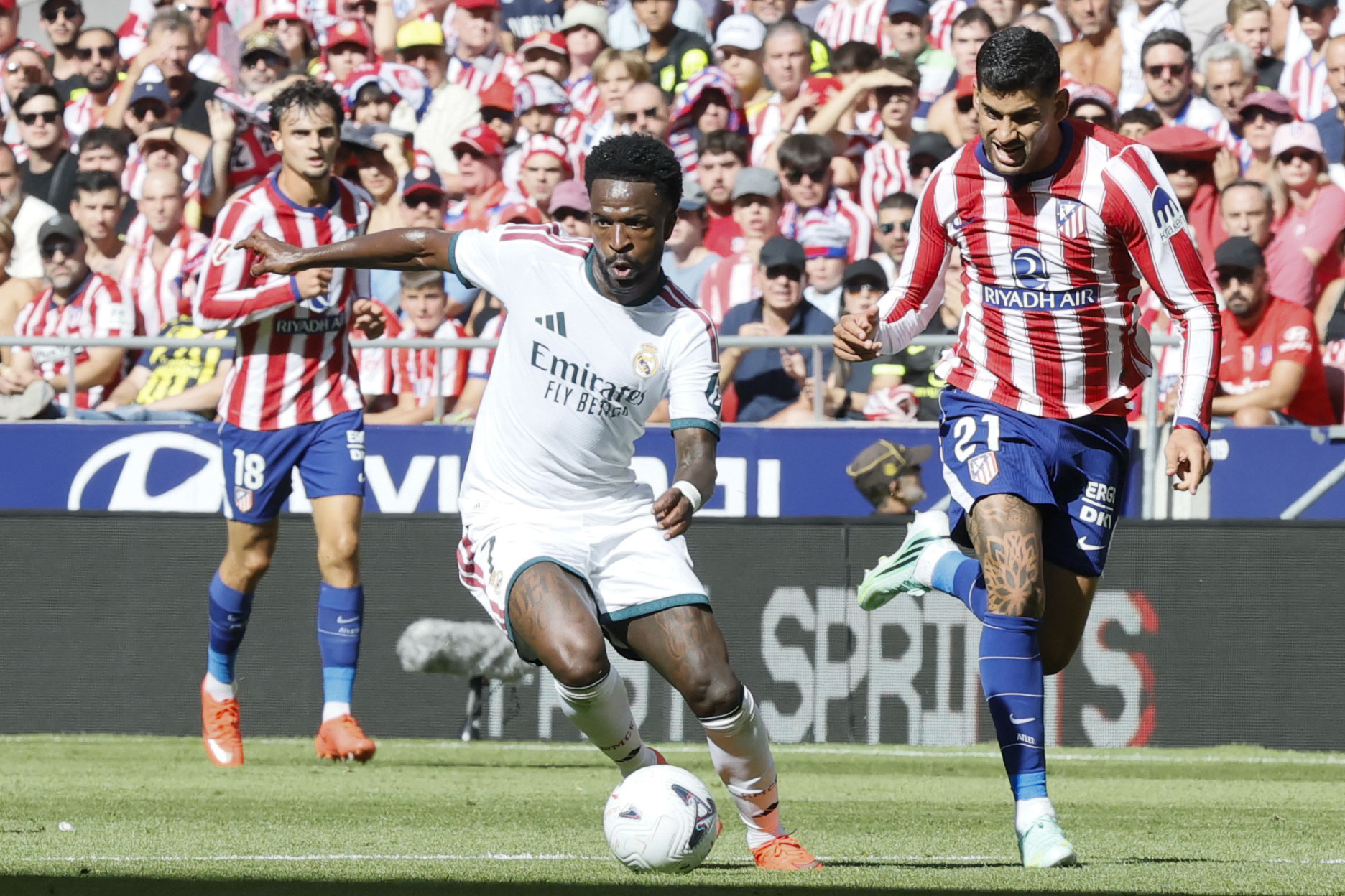 MADRID, 20/09/2026.- El defensa del Atlético de Madrid Cuti Romero (d) pelea un balón ante el delantero del Real Madrid Vinícius Júnior (c) durante el partido de LaLiga EA Sports entre Atlético de Madrid y Real Madrid celebrado este domingo en el del estadio Riyadh Air Metropolitano de la capital española. EFE/ Ballesteros