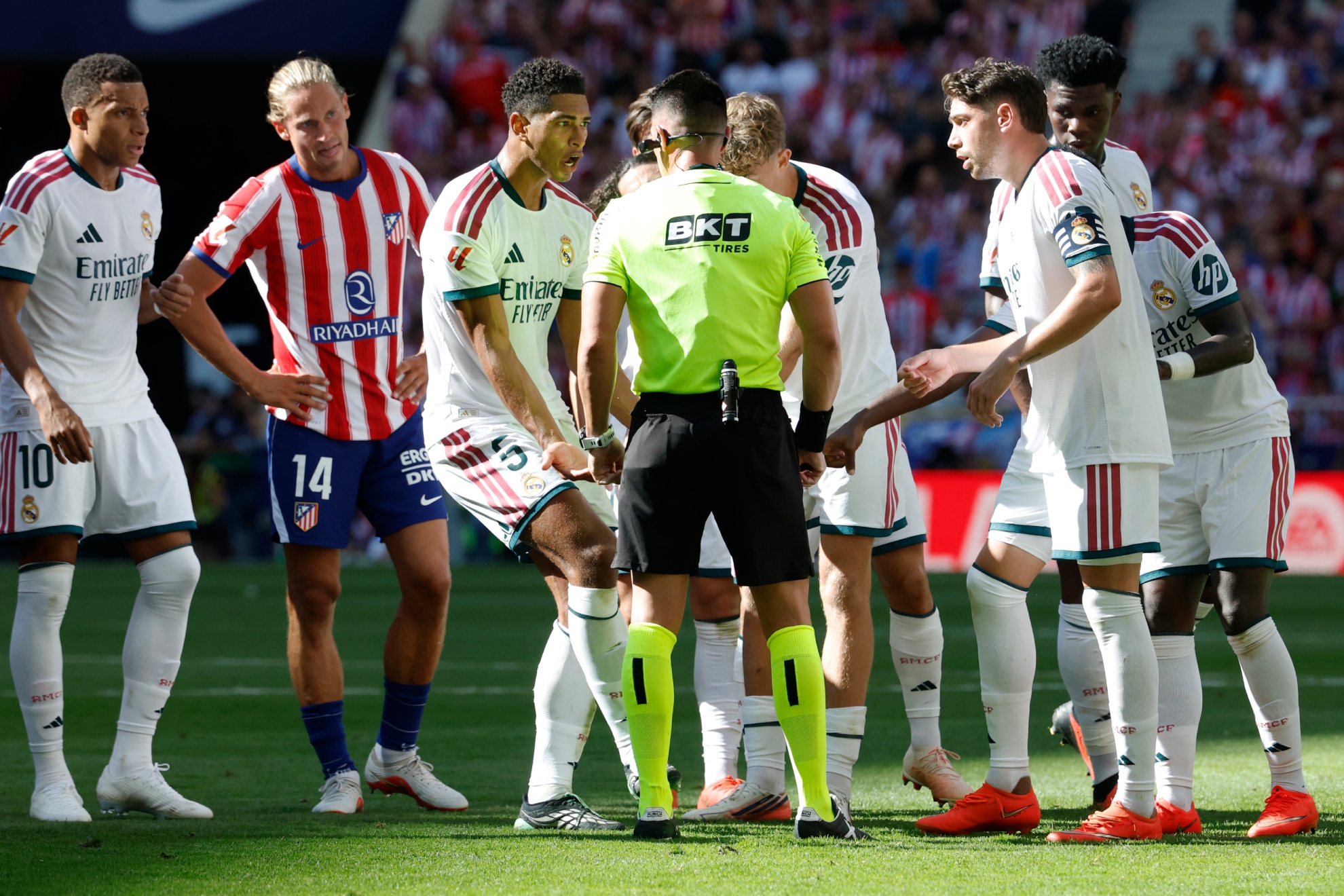 Los jugadores del Madrid protestan al colegiado durante el último derbi. CHEMA REY