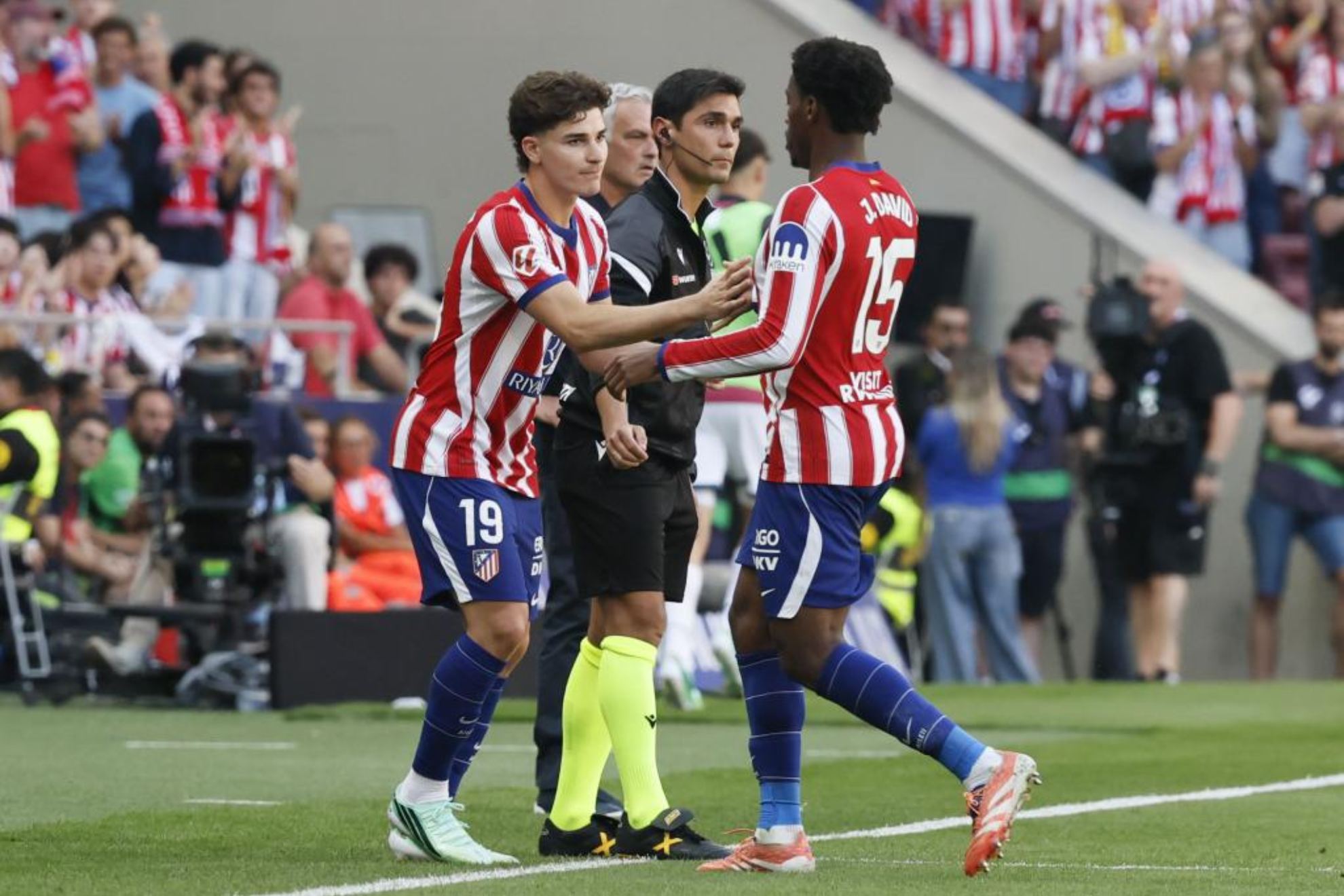 Julián y David, en un partido del Atlético.