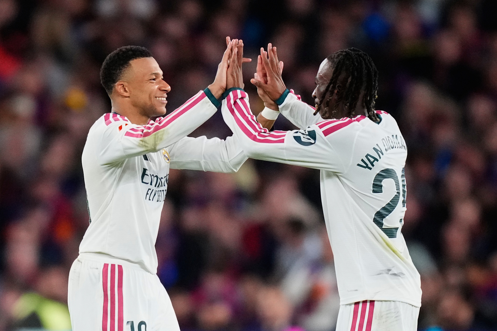 Real Madrid's Kylian Mbappe, left, celebrates with Real Madrid's Yan Diomande after scoring his side's second goal during a Spanish La Liga soccer match between FC Barcelona and Real Madrid in Barcelona, Spain, Sunday, Oct. 25, 2026. (AP Photo/Jose Breton)